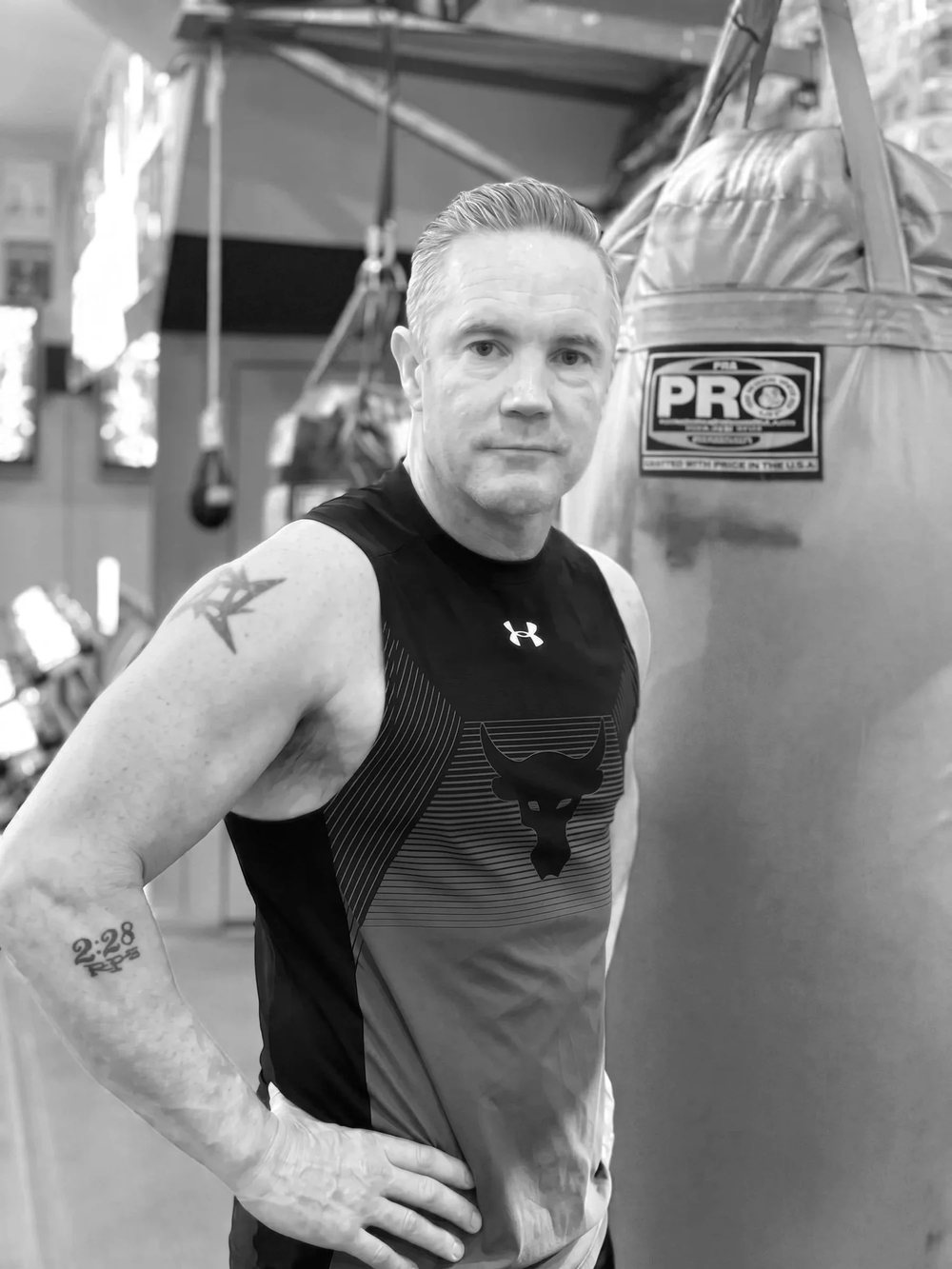 Simon Redmond standing beside a heavy bag